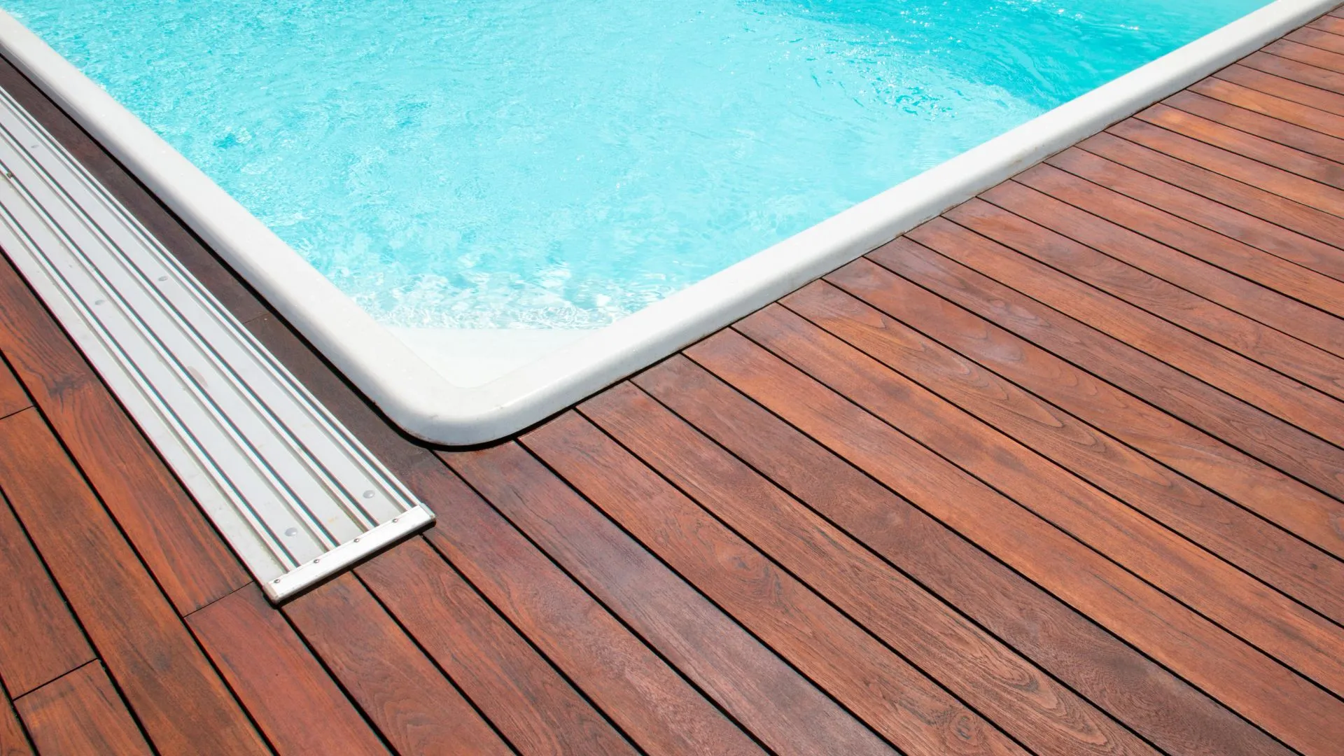Cool travertine pool decking around a backyard pool in Stone Oak, San Antonio